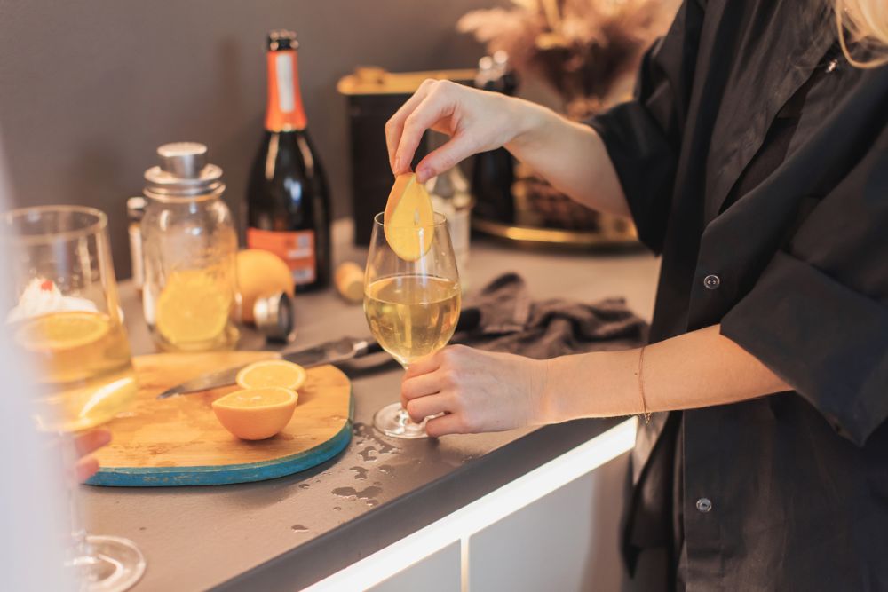 a woman making a white wine based drink