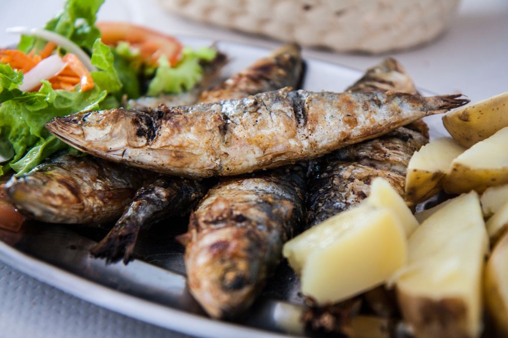 sardines served with potatoes and salad